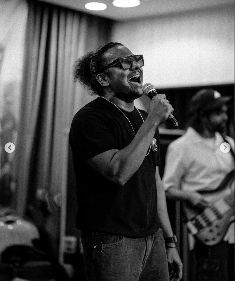 Jaabi Baapu, founder of MayGrid, performing with a microphone